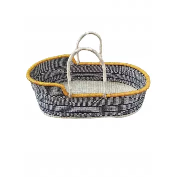 A handwoven baby Moses basket or bassinet with yellow edging and tan handles. A black and white pattern body