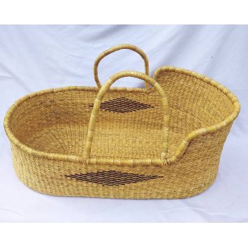 A handwoven tan baby Moses basket or bassinet with a black geometric central pattern  with tan handles.