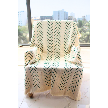 Front view of a white and green Bogolan African Mudcloth Fabric Piece covering a chair