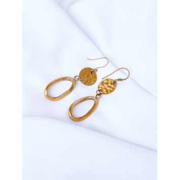 Flatlay of a pair of brass earrings placed on a white sheet