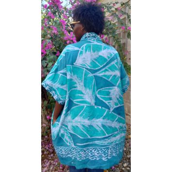Back view of a model wearing a green and white batik kaftan jacket