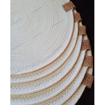 Top view showing a stack of white 12" cotton placemats
