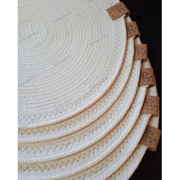 Top view showing a stack of white 12" cotton placemats