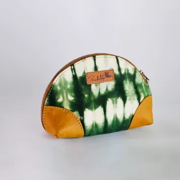 tie-dye green and white mini pouch bag with tan leather cutouts on the sides of the bag