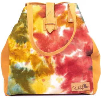 a bright red, yellow canvas bag with pure leather straps. the hand-dyed tote bad has a tie-dye effect