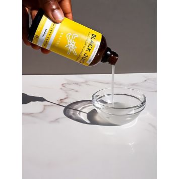 A side view of Buttery Vanilla Bakery Emulsion being poured into a bowl