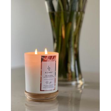 Ajani Binti Scented Candle
in front of a vase with flower stems