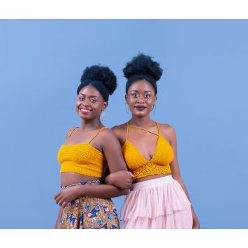 Front and side views of two models wearing assorted yellow crochet bralettes