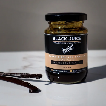 A front view of a 100ml jar of Baker's Edition Vanilla Bean Paste with vanilla sticks on the side.