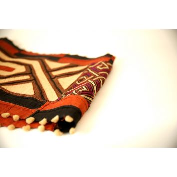 Top view of a folded multi-color Kuba textile table runner