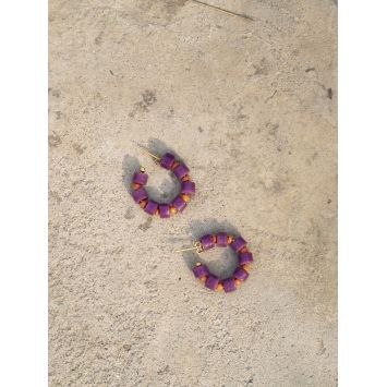 Flatlay of a pair of purple and orange Bodee Earrings