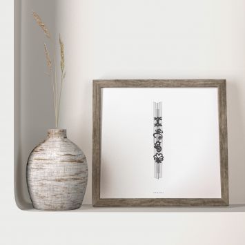 A black and white painting on a white background, framed and placed next to a vase