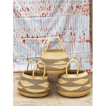 Side view of three bolo bolga baskets with diamond patterns stacked in natural tan