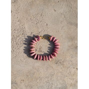 Flatlay of a pink Ehann Bracelet on the floor