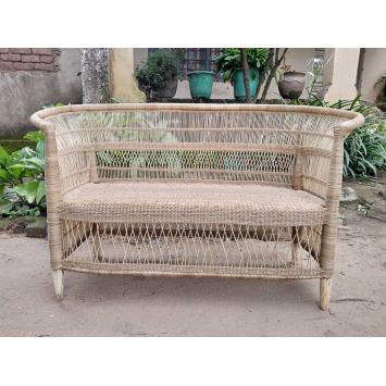 Front view of a tan cane and bamboo double seater chair placed outside