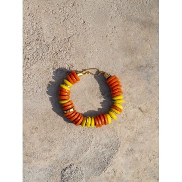 Flatlay of an orange and yellow Obuo Bracelet on the floor