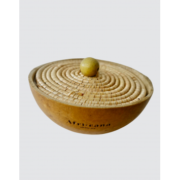 A cane covered half calabash with Shea butter or Black African Soap