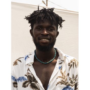 Front view of model wearing a green Wenne necklace