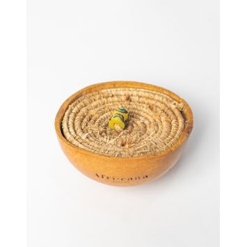 A top side view of neutral-colored Raffia Cover which covers a calabash.